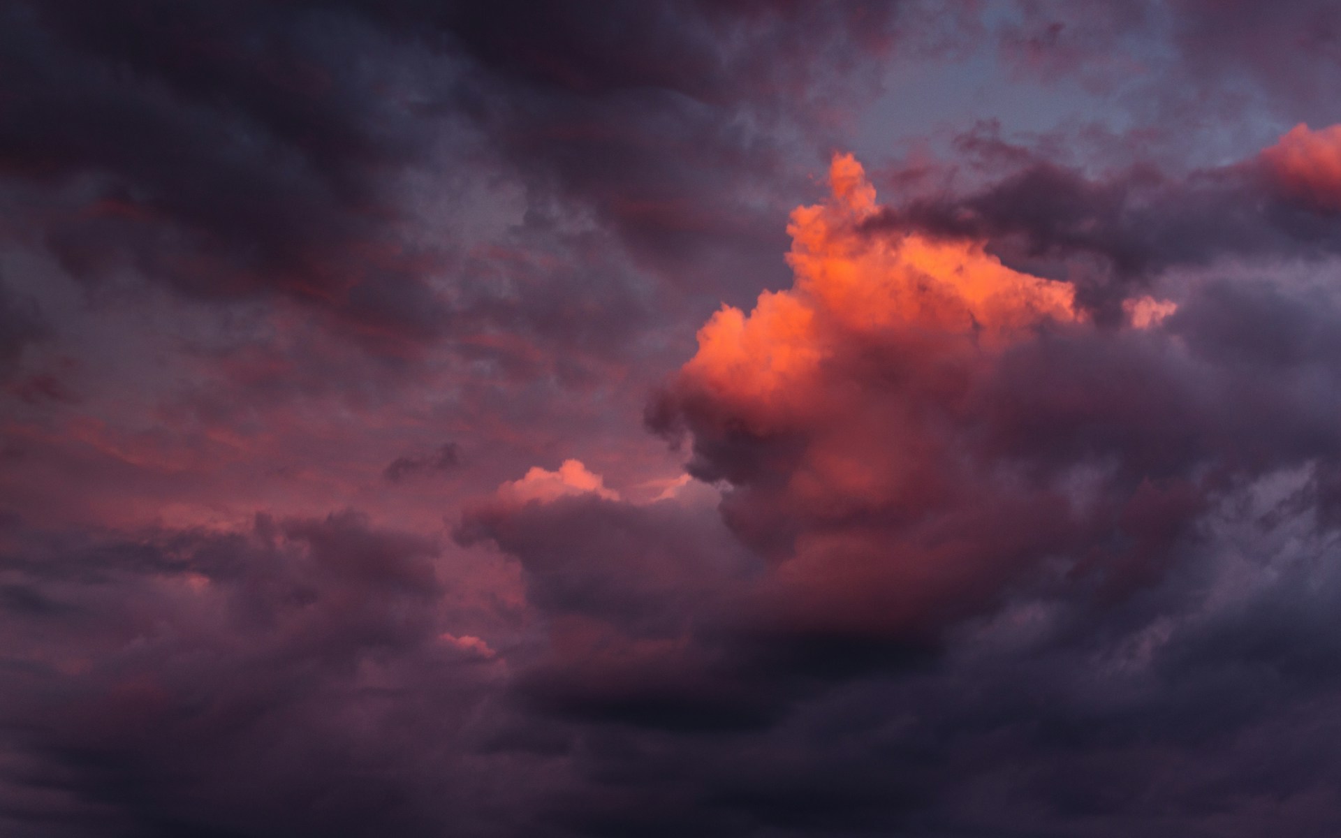 Decorative cloud graphic with layered sky tones.